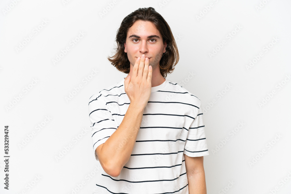 Young handsome man isolated on white background covering mouth with hand Young handsome man isolated on white background covering mouth with hand