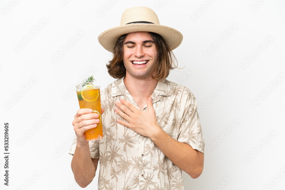 Young handsome man holding a cocktail isolated on white background smiling a lot Young handsome man holding a cocktail isolated on white background smiling a lot