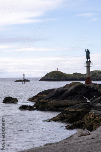 Svolvaer, Austvagoya, Lofoten Norway - July 17, 2022: Fiskerkona sculpture, the fisherman's wife is waving goodbye to the fishermen who are leaving for the high seas Summer cloudy day Selective focus