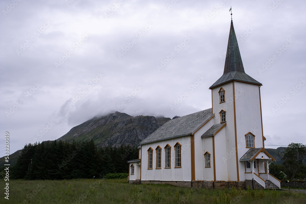 Valberg, Norway - July 18, 2022: Valberg Church is a parish church of the Church of Norway in Vestvagoy Municipality in Nordland county. Cloudy summer day. Selective focus
