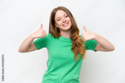 Young pretty woman isolated on white background giving a thumbs up gesture © luismolinero