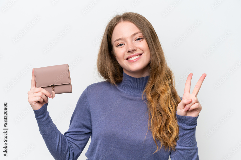 Young pretty woman holding wallet isolated on white background smiling and showing victory sign Young pretty woman holding wallet isolated on white background smiling and showing victory sign
