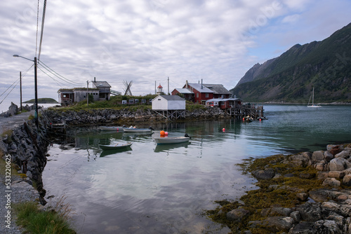 Wonderful landscapes in Norway. Nordland. Beautiful scenery of Senja coastline at Bovaer on the Senja scenic route. Mountains and houses in background. Cloudy day. Selective focus photo