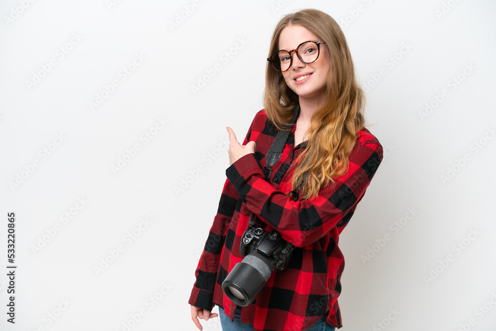 Young photographer pretty woman isolated on white background pointing back Young photographer pretty woman isolated on white background pointing back