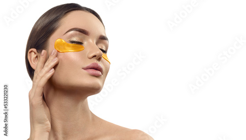 Woman with patches, under eye collagen gold pads, beauty model girl face with healthy fresh skin. Skin care concept, anti-aging moisturizing eye mask, golden hydrogel, eye skin treatment, cosmetology