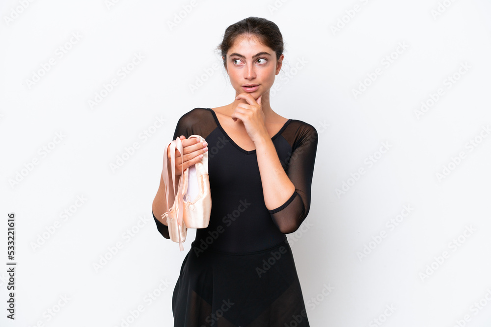 Young caucasian woman practicing ballet isolated on white background looking to the side and smiling Young caucasian woman practicing ballet isolated on white background looking to the side and smiling