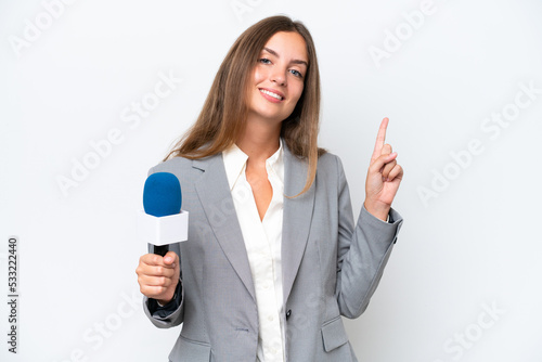 Young TV presenter caucasian woman isolated on white background showing and lifting a finger in sign of the best