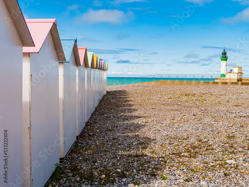 Colored bathing huts and lighthouse at Le Treport beach, Normandy, France
 photo