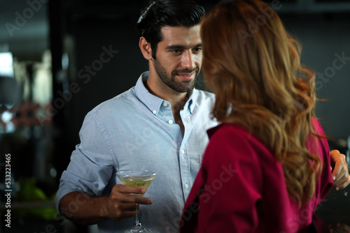 Man and woman flirting with each other in bar At Evening Party. Romantic couple dating at night in pub. couple dating   propose marriage. Romantic couple on a date sitting in a restaurant.