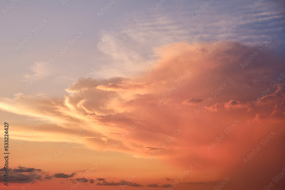 Big clouds in the red sunset sky. Evening sky in bright sunlight