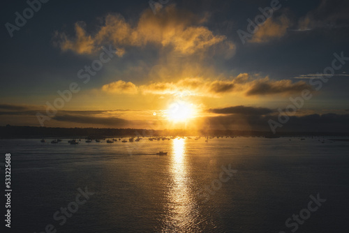 yellow blue sunset sunrise clouds over sea ocean boat port harbour