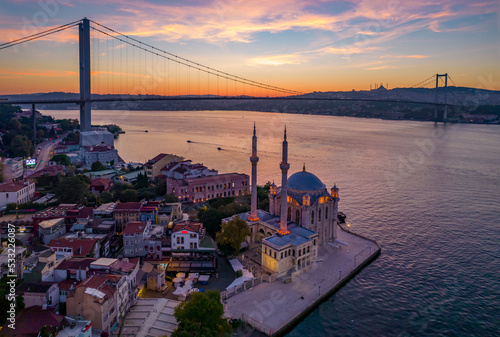 ORTAKOY, ISTANBUL, TURKEY. Aerial view of Istanbul. Ortakoy Mosque and Bosphorus Bridge (15th July Martyrs Bridge) sunrise view. Drone shot.
