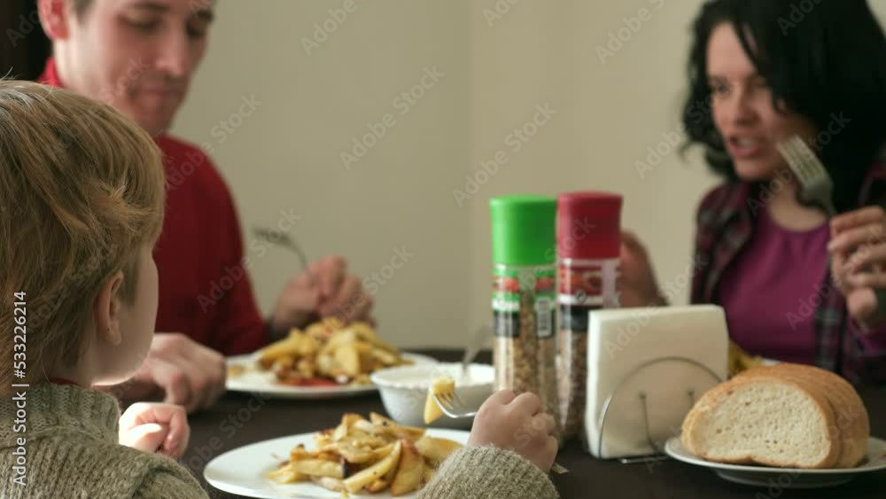 Young Family with Child Eat Breakfast Dinner. Father Mother Kid Having Meal Together. Prepared Fresh Fried Potato Dish on Table. 2x Slow motion 60 fps 4K