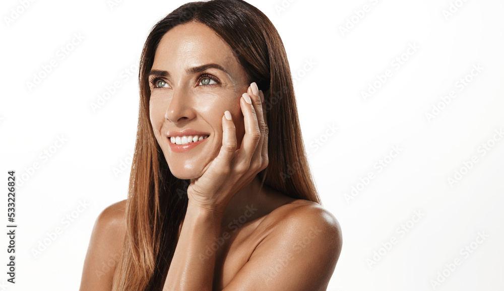 Beauty portrait of mature woman smiling with hand on face. Closeup face of happy adult, 40s years, woman feeling fresh after anti-aging treatment. Smiling beauty looking at camera with perfect skin Beauty portrait of mature woman smiling with hand on face. Closeup face of happy adult, 40s years, woman feeling fresh after anti-aging treatment. Smiling beauty looking at camera with perfect skin