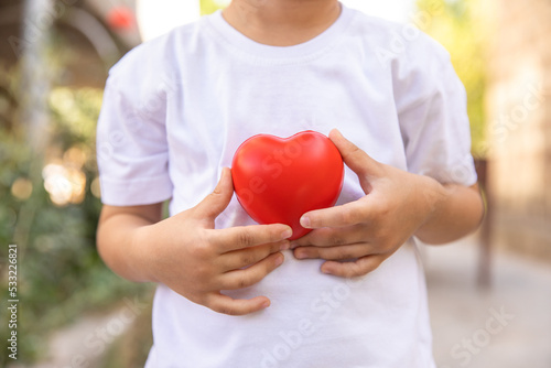 Child holding a heart in his hand