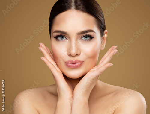 Beauty Model showing Cheekbones and Full Lips. Beautiful Woman Face Skin Care. Women Dermal Filler and Permanent Make up Cosmetology. Lip Augmentation Facial Lifting Spa Massage photo
