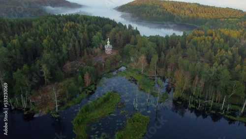 Flight on a drone over the Putsaari island of Lake Ladoga over the Church of St. Sergius and Herman