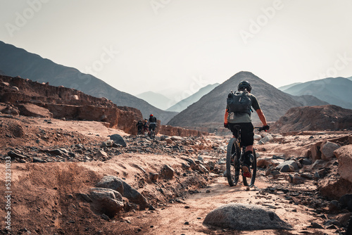 man riding his bike in the desert.