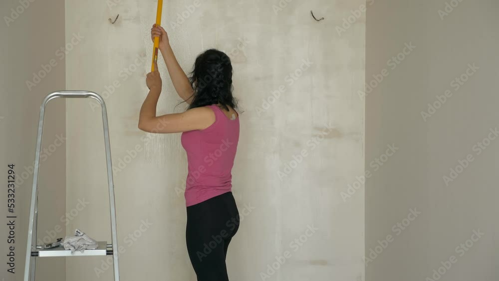 Woman Glue Wallpaper on Wall Doing Renovation in New Flat Apartment. 2x Slow motion 60 fps 4K Woman Glue Wallpaper on Wall Doing Renovation in New Flat Apartment. 2x Slow motion 60 fps 4K