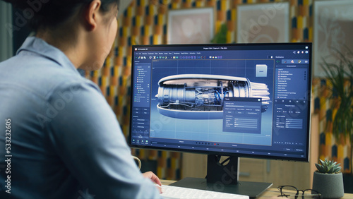 Female 3D designer using pc with professional program and creating 3D prototype of airplane turbine while working remotely at home office photo