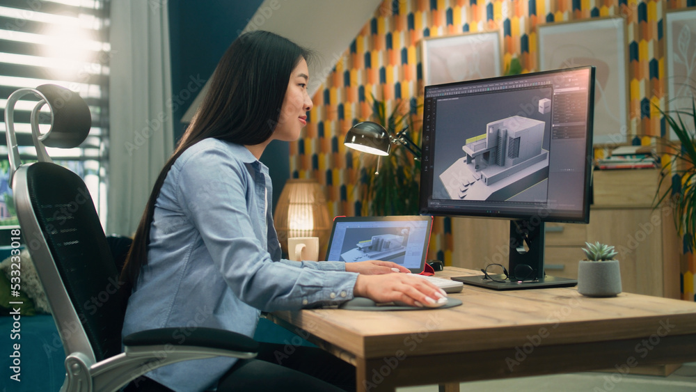 Female asian 3D designer at home working on 3D modeling project of house and making exterior in professional computer program using pc and digital tablet Female asian 3D designer at home working on 3D modeling project of house and making exterior in professional computer program using pc and digital tablet