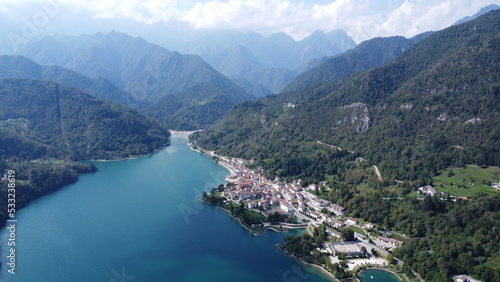 Scenic aerial footage of Barcis  Italy. Fascinating aerial views of Barcis Village  Lake Barcis and Dolomites mountains  Alps .