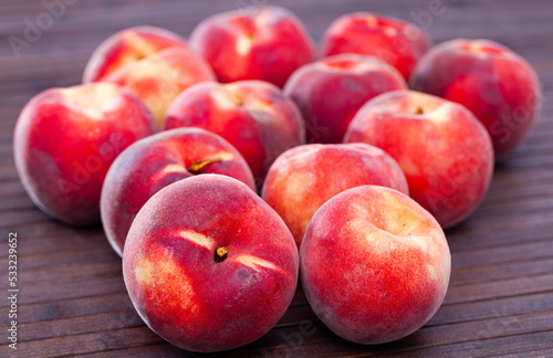 Group of fresh sweet peaches on wooden table