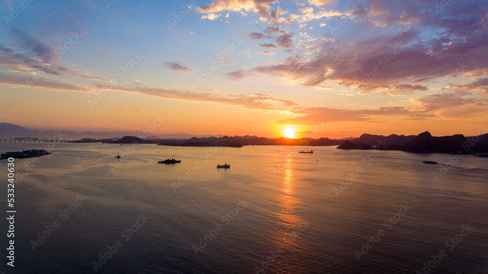 Aerial view of Guanabara Bay at dawn, one of Rio de Janeiro's postcards. In the background the mountains of the state.