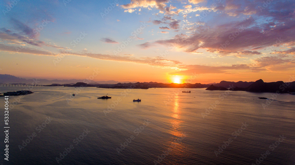Fototapeta premium Aerial view of Guanabara Bay at dawn, one of Rio de Janeiro's postcards. In the background the mountains of the state.