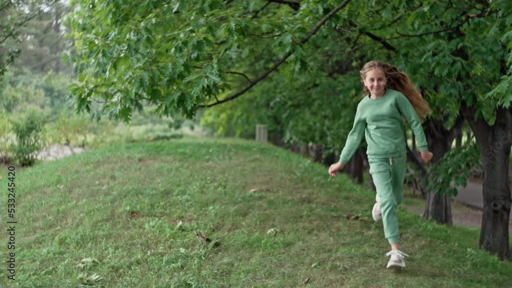 Caucasian smiling girl running in the park. Happy childhood of a teenage girl. Conceptual lifestyle. High quality 4k footage Caucasian smiling girl running in the park. Happy childhood of a teenage girl. Conceptual lifestyle. High quality 4k footage