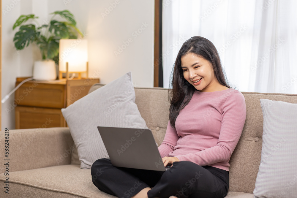 Recruitment Concept. Girl Browsing Work Opportunities Online on sofa at home, Happy Asian woman Using Job Search App or Website on Laptop, Copy Space Recruitment Concept. Girl Browsing Work Opportunities Online on sofa at home, Happy Asian woman Using Job Search App or Website on Laptop, Copy Space