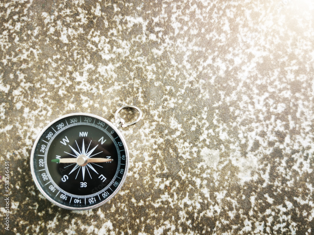 Close-up of a compass lying on the ground concept of travel