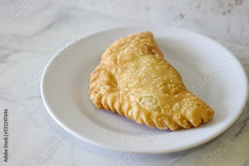 Cornish pasty filled with chicken and potato. Pastry minced pie or Pastel asian style cuisine. Homemade flaky pasty with mince meat filling	
