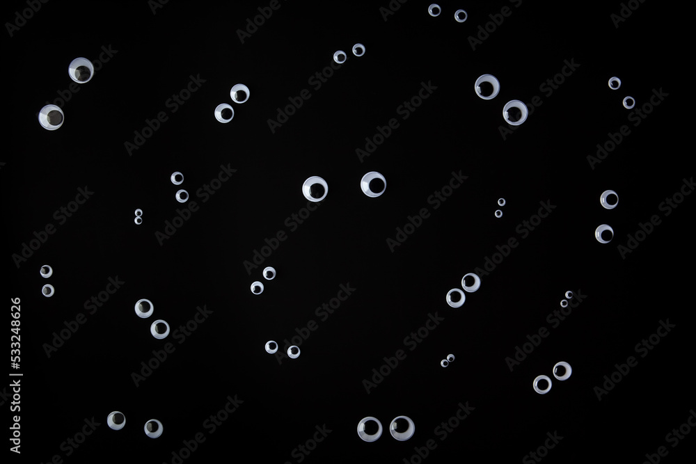 Funny face made from jiggly eyes on black background Funny face made from jiggly eyes on black background