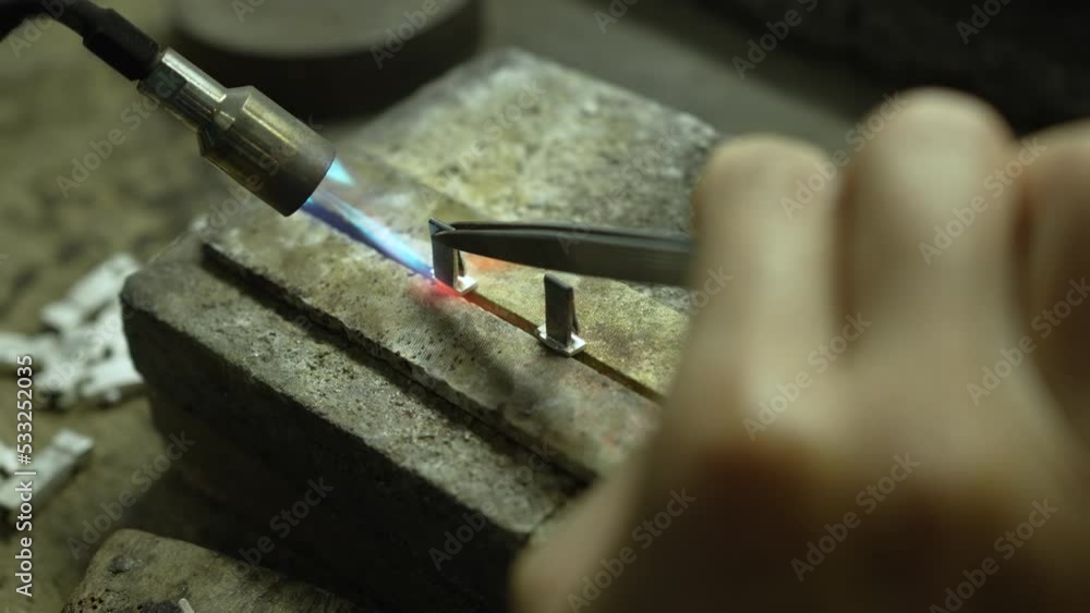 Jeweler at work in jewelry. Desktop for craft jewelry making with professional tools. Close up view of tools. Thailand. Jeweler at work in jewelry. Desktop for craft jewelry making with professional tools. Close up view of tools. Thailand.