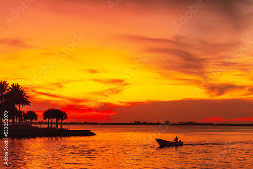 Boat at sea at sunset twilight sky