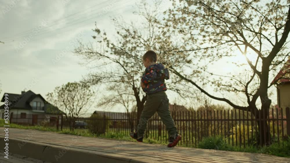 child boy running in rural landscape. Happy smiling child in spring at sunset. High quality 4k footage child boy running in rural landscape. Happy smiling child in spring at sunset. High quality 4k footage