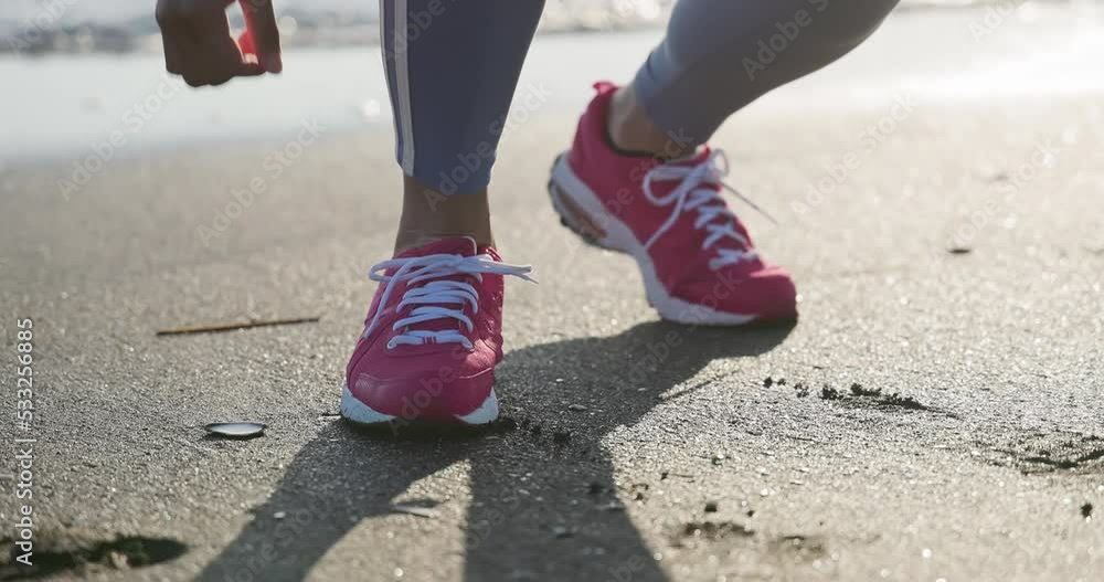 asian female runner tying shoelace asian female runner tying shoelace