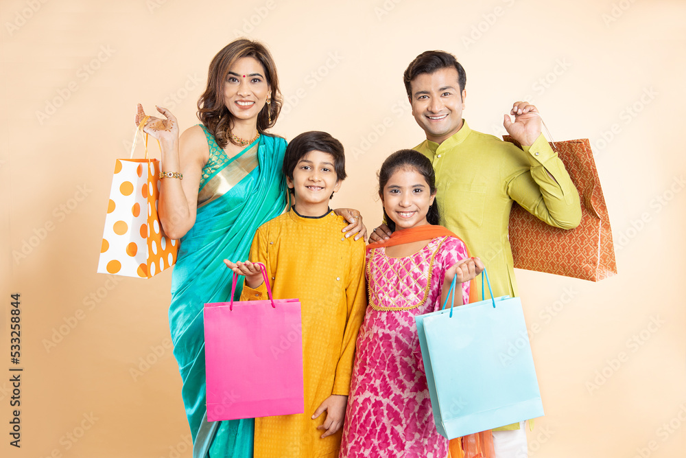 Portrait Of Happy Indian Family Wearing Traditional Cloths Holding portrait-of-happy-indian-family-wearing-traditional-cloths-holding