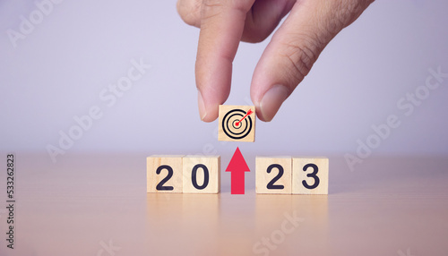new year 2023 and goal plan, wooden cube hand holding with new year 2023 and goal or target icon New Year's Business Goals and Vision Ideas,Copy Space