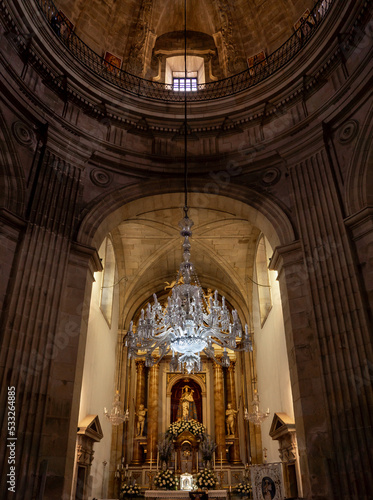 Hanging glass lamp of the Pilgrim in the church of Pontevedra with the altar in the background beautifully lit photo