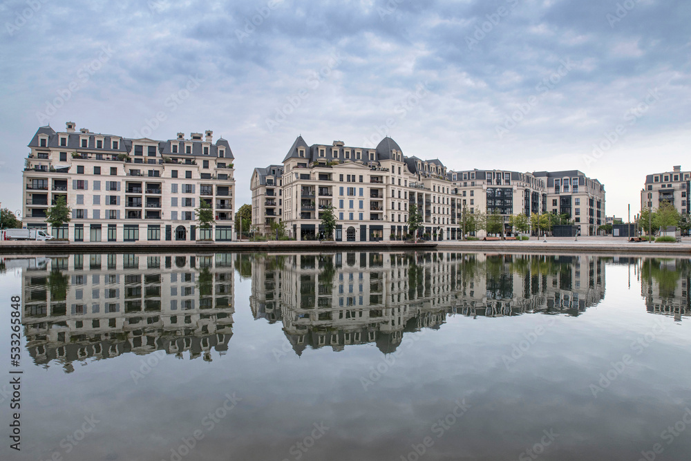 Modern architecture of apartment buildings in a residential area on a lake
