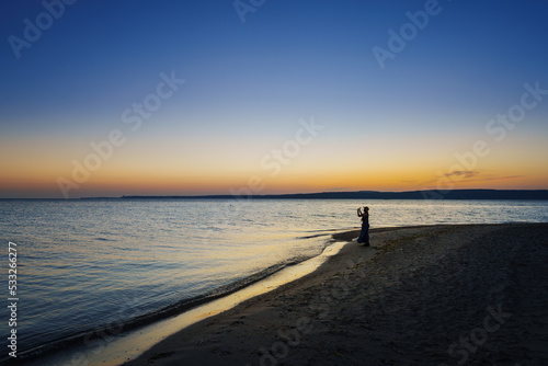 Traveler asian woman with her summer vacations on a twilight beach by the sea her fell lonely dramatic but freedom. Aegean Sea Beach, Canakkale, Turkye. Leave a blank and space for text entry