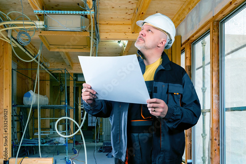 Worker in house under const...