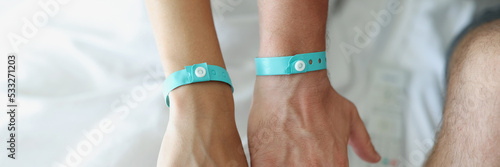Slika na platnu On the male and female hands a blue hotel bracelet