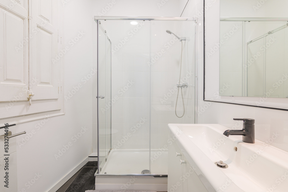 Modern white bathroom with shower cabin in renovated apartment. Modern white bathroom with shower cabin in renovated apartment.