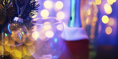 Closeup of glass Christmas ball on abstract light background.