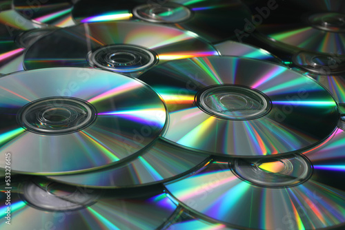 Heap of DVD, CD disks on white