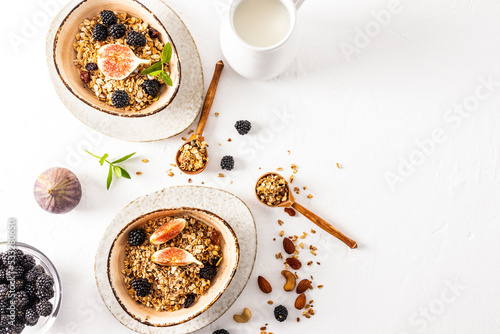 top view of the bowl with a healthy healthy breakfast of granola or muesli and ingredients for its preparation. white background. Detox.