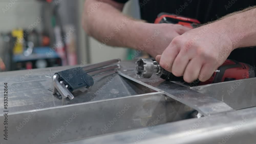 Man's Hands Disassembling Holesaw Drill Bit Cutter Tool at Workshop Man's Hands Disassembling Holesaw Drill Bit Cutter Tool at Workshop